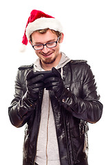 Image showing Young Man with Santa Hat Using Cell Phone