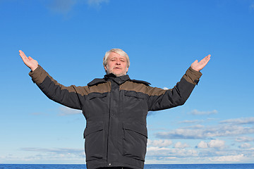 Image showing Middle-aged man on blue sky of the background.