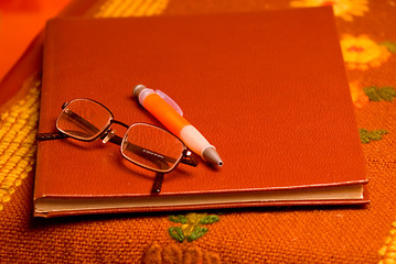 Image showing brown notes and pen