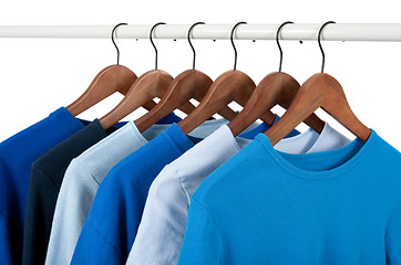 Image showing Casual shirts on hangers, different tones of blue