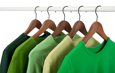 Image showing Casual shirts on hangers, different tones of green