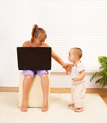 Image showing Girl pushing away her brother