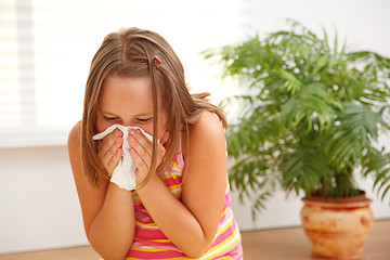 Image showing Teen girl blowing out her nose