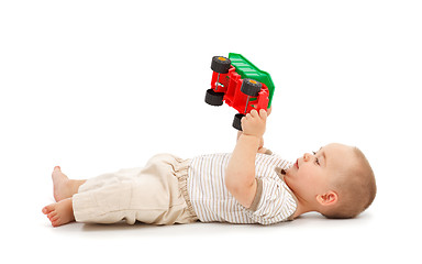 Image showing Boy playing with plastic toy car