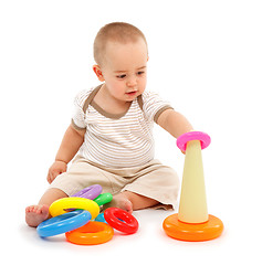 Image showing Little boy sitting and playing