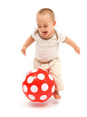 Image showing Little boy playing with red ball