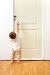 Image showing Baby boy in front of door