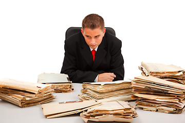 Image showing Man looking at lots of documents