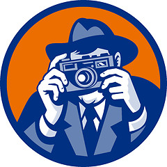 Image showing Photographer with fedora hat aiming retro slr camera