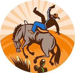 Image showing cowboy falling off horse