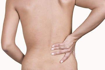 Image showing Woman massaging lower pain back
