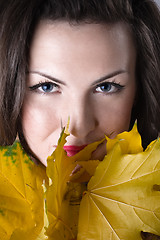 Image showing young woman with yellow leaves 