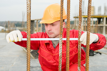 Image showing builder with measure tape