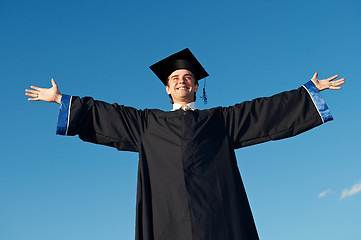 Image showing graduate with open arms outdoors