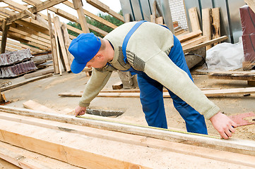 Image showing roofing works with measuring tape