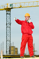 Image showing builder operating the tower crane