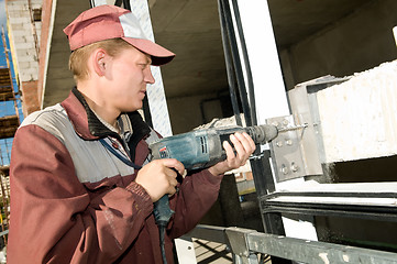 Image showing worker with drill