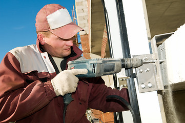 Image showing builder with drill