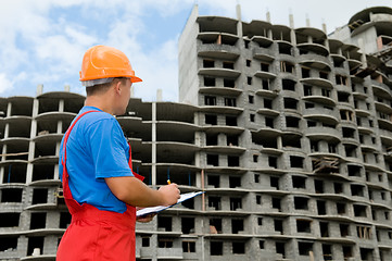 Image showing builder and building under construction