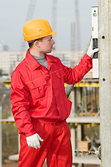 Image showing builder with digital level