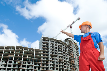 Image showing builder and building under construction