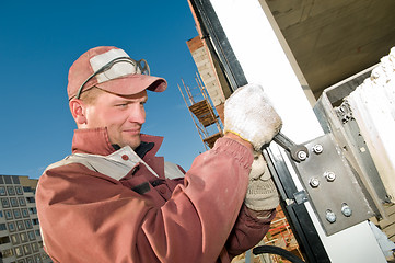 Image showing laborer and spanner wrench