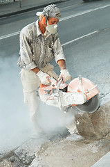 Image showing builder at stone cutting work