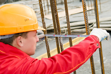 Image showing builder with measure tape