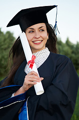 Image showing happy smiley graduate girl with diploma