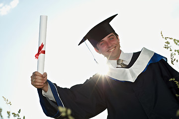 Image showing graduate with a diploma in backlight
