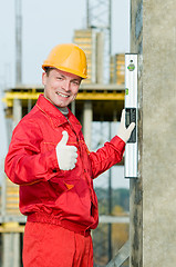 Image showing builder with digital level