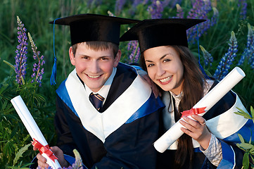 Image showing Two smiley Graduate outdoors