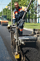 Image showing Young paver worker at asphalting works