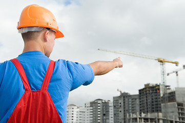 Image showing builder and building under construction