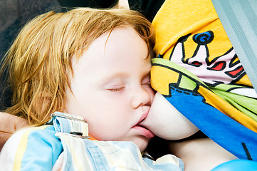 Image showing Sleeping child breastfeeding