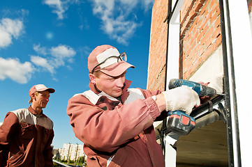 Image showing two workers with screwdriver