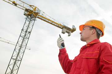 Image showing builder operating the tower crane