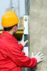 Image showing builder with digital level