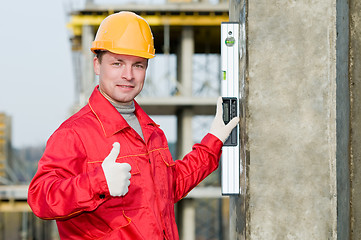 Image showing builder with digital level