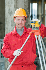 Image showing smiling surveyor builder and level