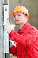 Image showing builder with digital level