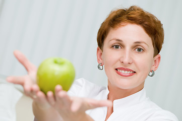 Image showing smiley dentist with apple