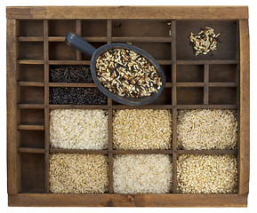 Image showing variety of rice grains in vintage wooden drawer with scoop