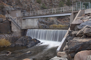 Image showing diversion dam on a mountain river flowing in deep, dark canyon