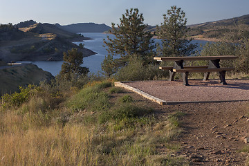 Image showing picnic table on shore of mountain reservoir