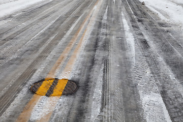 Image showing slippery icy road with yellow line