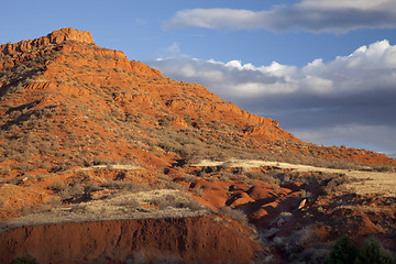 Image showing eroded red mountain with sparse vegetation