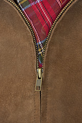 Image showing unzipped brass zipper of leather jacket