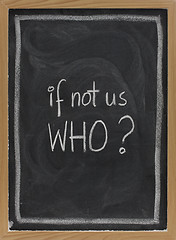 Image showing if not us, who - question on blackboard