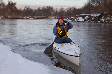 Image showing paddling canoe on a winter river